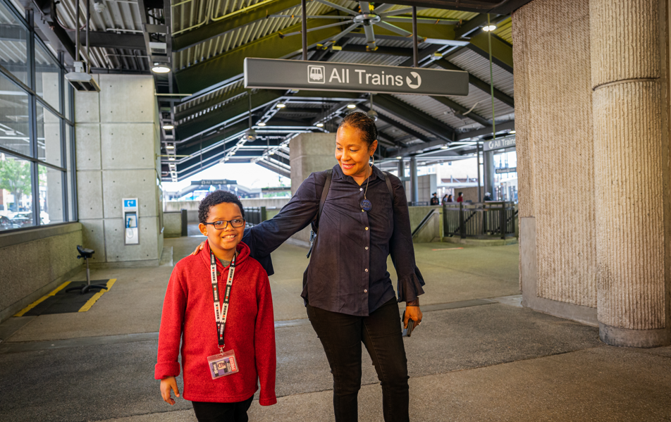 Immanuel Stephens and his mother, Lisa Stephens, stand at a MARTA train station platform