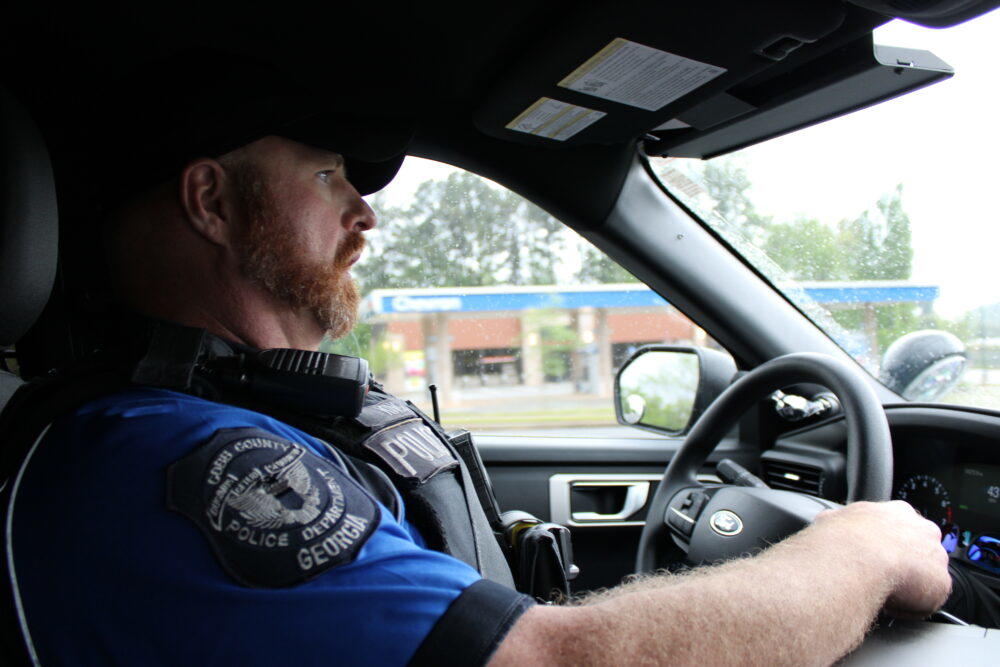 Officer Jacob King drives in his unmarked black Ford Explorer to follow up and build rapport with a resident his unit met. 