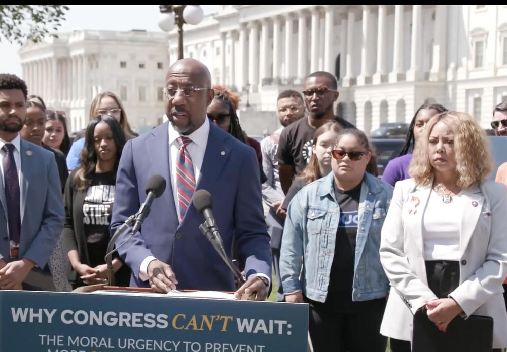 Sen. Raphael Warnock, left and Rep. Lucy McBath, right, urge Congress to take up new gun regulations.