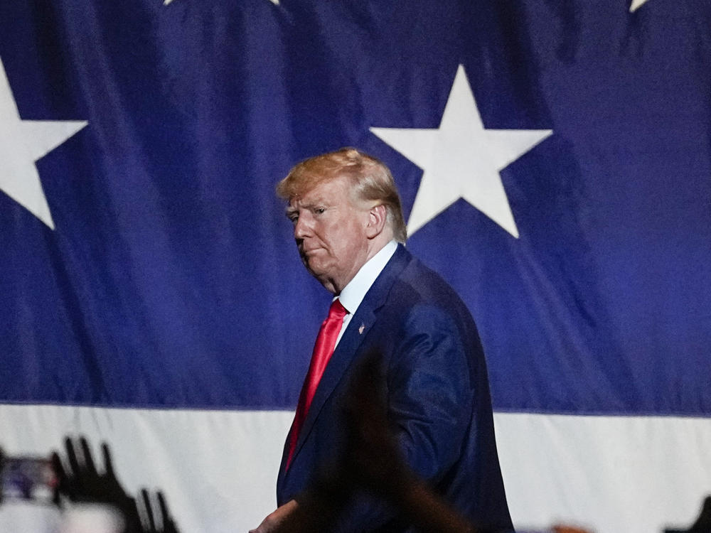 Former President Donald Trump exits the stage after speaking at the Georgia Republican convention on Saturday, in Columbus, Ga., his first public appearance responding to the unsealing of his federal indictment. / AP