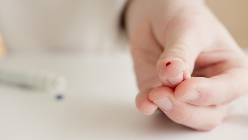 A blood drop on a finger 