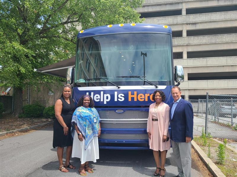 Fulton County Behavioral Health Director LaTrina Foster, far left, along with Fulton County Manager Dick Anderson, far right, attend the first stop of the Mobile Mental Health Unit on June 2, 2023.
