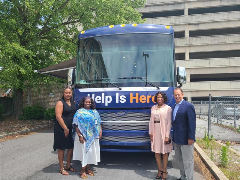Fulton County Behavioral Health Director LaTrina Foster, far left, along with Fulton County Manager Dick Anderson, far right, attend the first stop of the Mobile Mental Health Unit on June 2, 2023. 