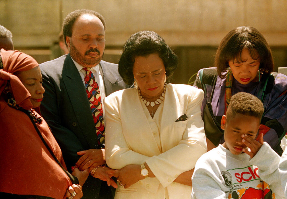 Family members of the slain civil rights leader Dr. Martin Luther King Jr., left to right, sister Christine King-Farris, son Martin Luther King III, widow Coretta Scott King, daughter Yolanda King and an unidentified young boy, pray at his tomb in Atlanta, Ga., Monday, April 4, 1994. The ceremony marks the 26th anniversary of King's death. 