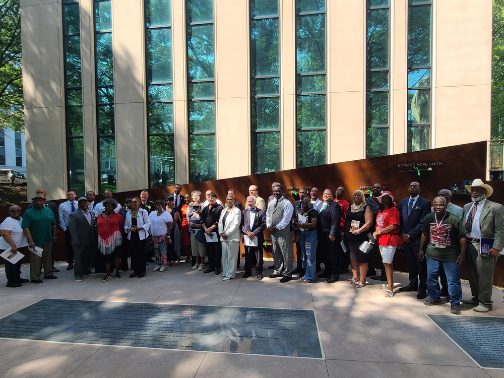 Family of the victims lost and city officials stand in front of the new Atlanta Child Murders Memorial. A 55 foot steel wall with the names of the 30 victims on it.