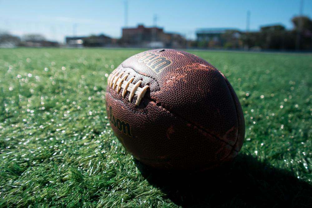 brown football on grass