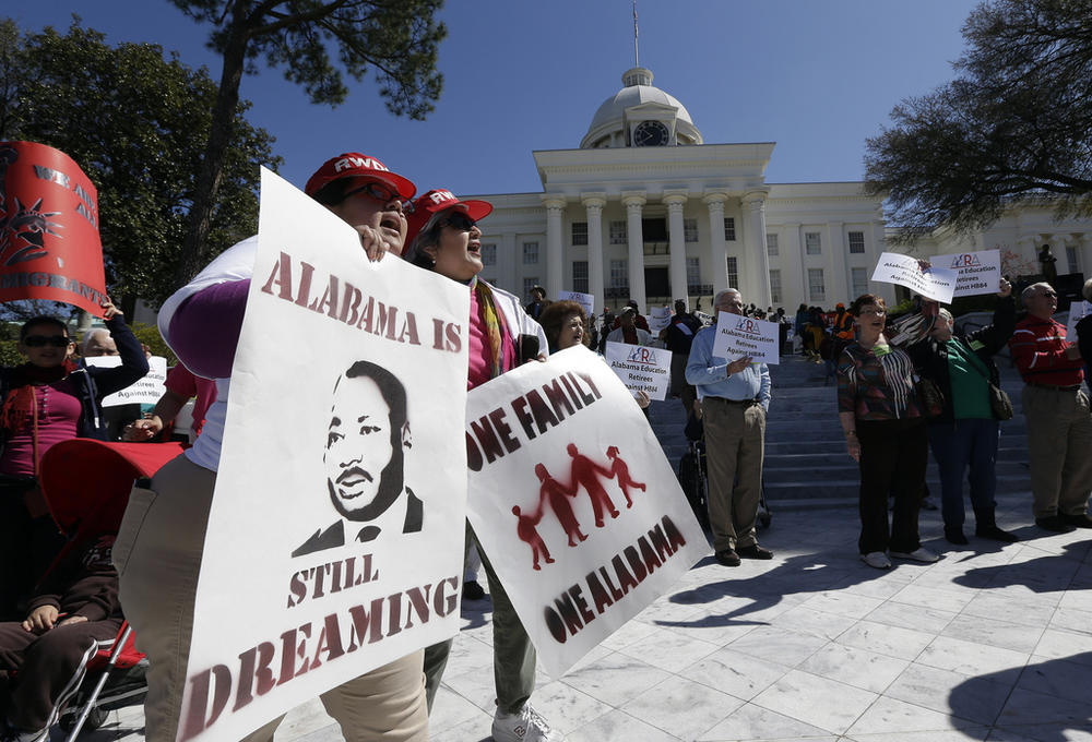 Demonstrators Gwendolyn Perrette, left, of Tuscaloosa, Ala., and Miriam Billanuava, of Birmingham, Ala., chant with others outside the Capitol in Montgomery, Ala., March 8, 2013.