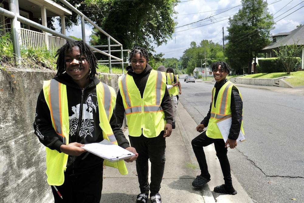 Terry Moss, Japheth Moss, and Algernon William help conduct a safety survey of the Pleasant Hill neighborhood as part of the Safe by Design project on June 24, 2023, in Macon, Ga.