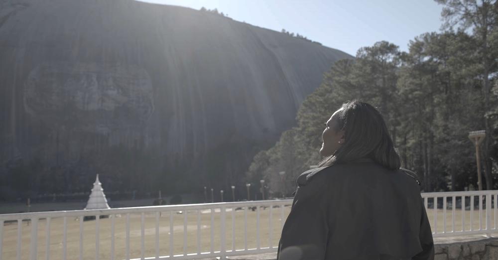 Derrica Williams staring up at Stone Mountain.