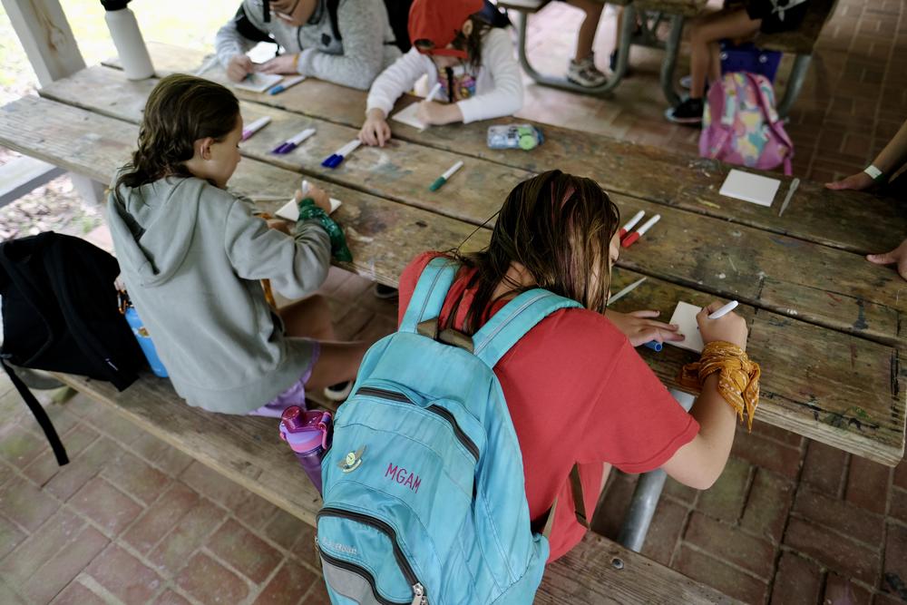 Camp attendees work on a craft project at Camp Martha Johnston in Crawford County, Ga. in July, 2023. Residents are concerned that a proposed rock quarry less than two miles away could bring noise and pollution to the camp, which has housed girl scouts every summer for nearly a century.