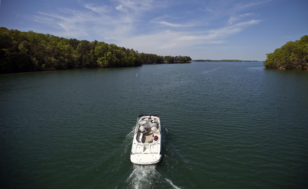 A boat passes along Lake Lanier, April 23, 2013, in Buford, Ga. Fashion designer Tameka Foster, the ex-wife of R&B singer Usher, is calling to drain Lake Lanier, Georgia's largest lake, where her son was fatally injured 11 years ago. Kile Glover, her 11-year-old son with Bounce TV chairman Ryan Glover, died in July 2012 after a personal watercraft struck the boy as he floated in an inner tube on the lake.