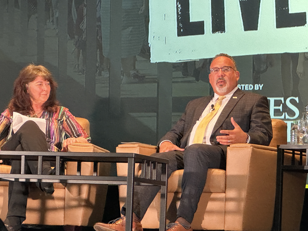 U.S. Education Secretary Miguel Cardona (right) spoke at Agnes Scott College on July 17 as part of an event moderated by The Atlanta Journal-Constitution's Maureen Downey.