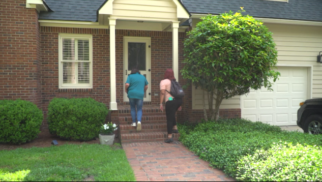 Two people arrive at the home of someone who called a mental health crisis line.