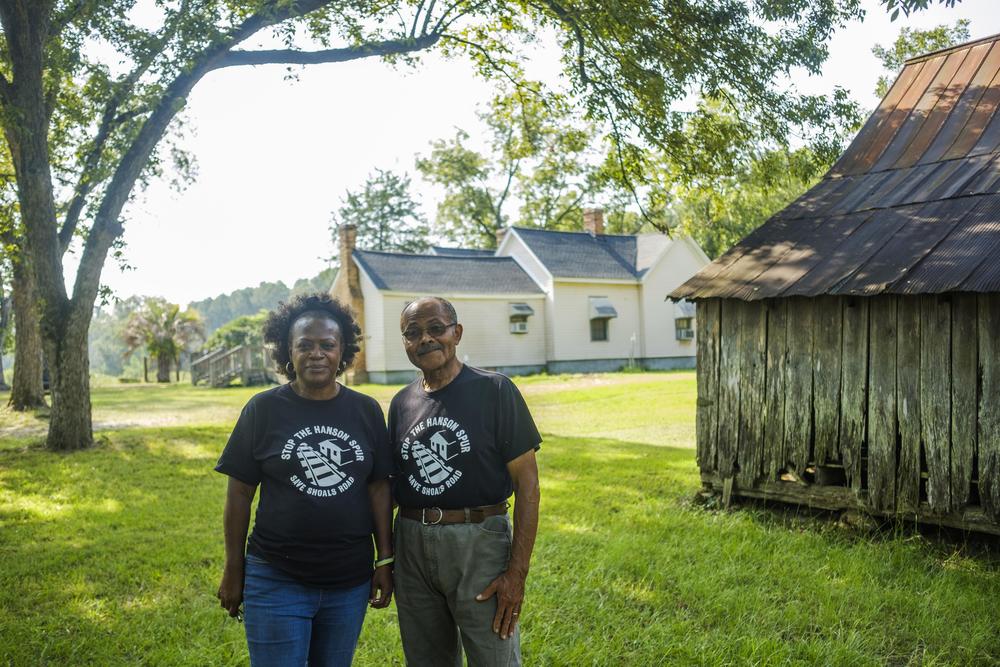 Jan and Mark Smith by the home where Mark was raised, background, and the barn his grandfather built in 1926, right. 