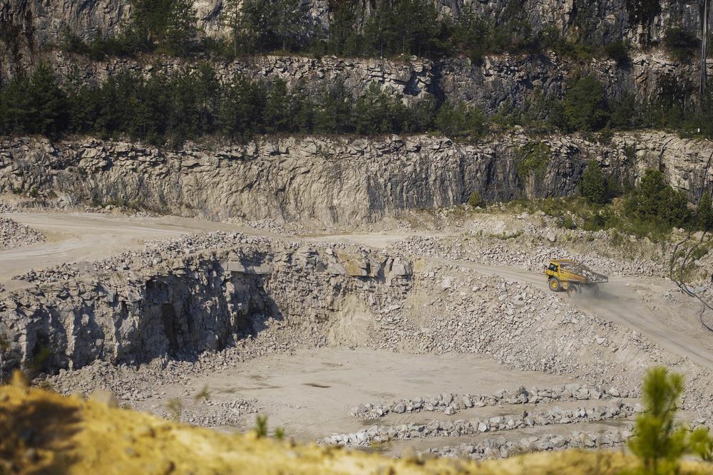 A large dump truck called a yuke carries granite boulders up from the working face of the Heidelberg Materials quarry on Shoals Road in Hancock County. 