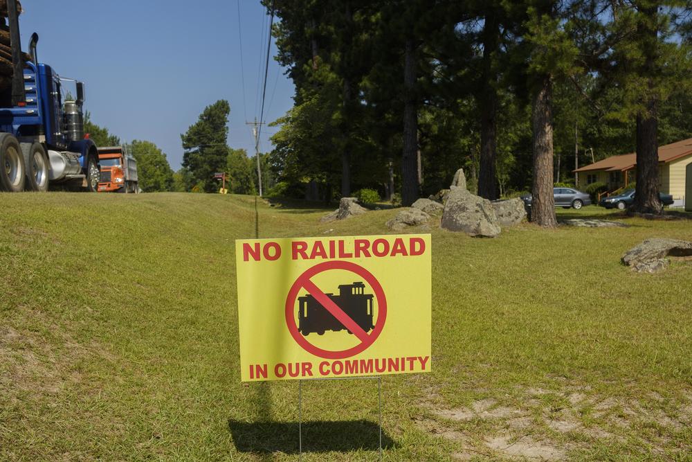 One of a number of signs voicing opposition to the rail spur project along Shoals Road in Hancock County.  