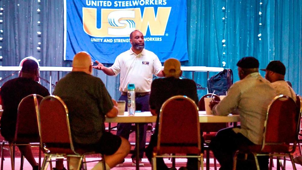 Alex Perkins, a staff representative with the United Steelworkers, speaks to Blue Bird employees during a training session for the bargaining committee in June.