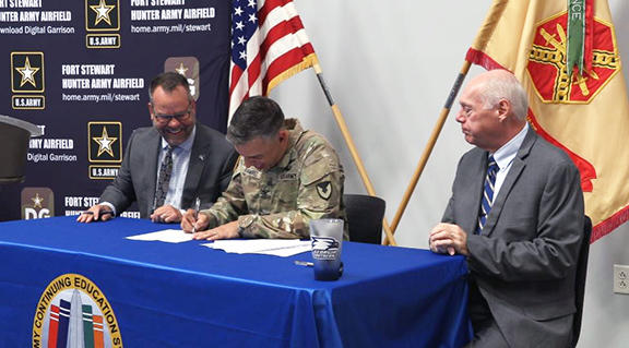 Fort Stewart-Hunter Army Airfield Garrison Commander Col. Manuel Ramirez signs an agreement with Georgia Southern University officials at Fort Stewart near Hinesville on July 31, 2023.