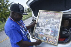  “General” Larry Platt shows a collage of photos from the civil rights era. 