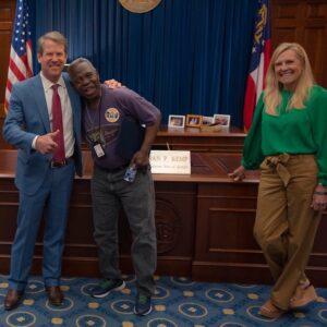 Gov. Brian Kemp, “General” Larry Platt and first lady Marty Kemp share a laugh in the governor’s office after Kemp signed a proclamation honoring Platt.