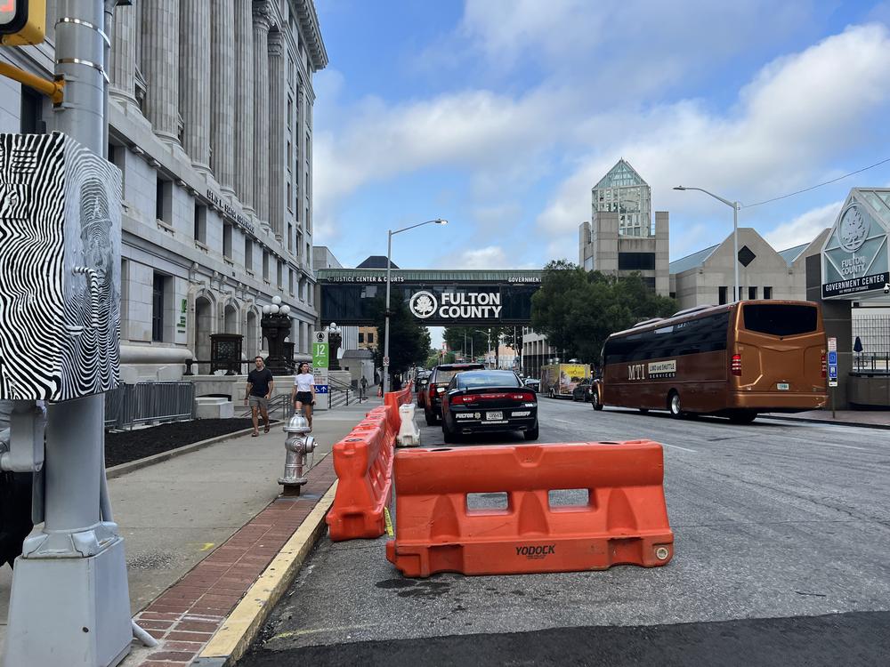 Security preparations outside the Fulton County courthouse include barricades and eventual street closures ahead of the announcement of indictments.