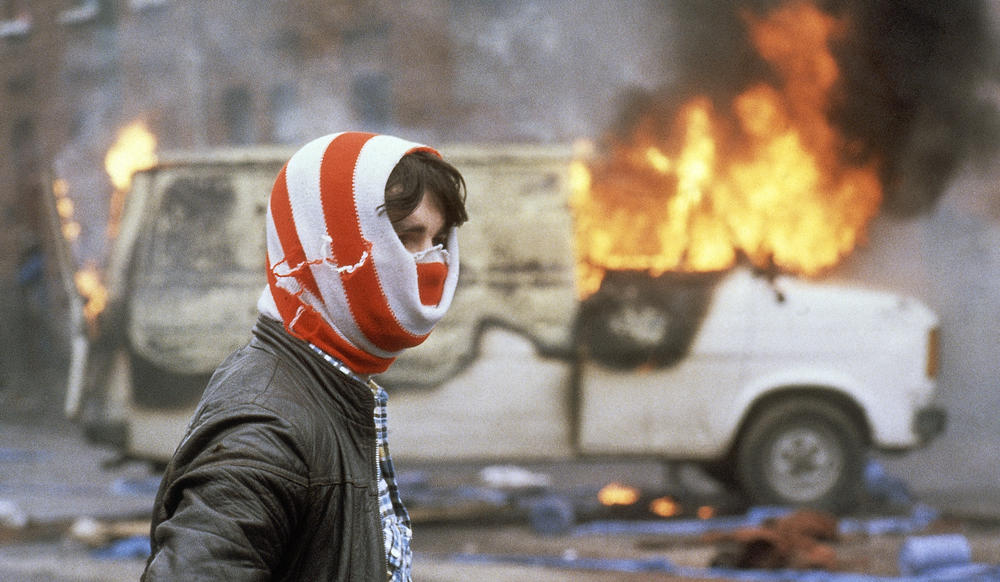 Youth in front of a blazing van, Belfast 1981.