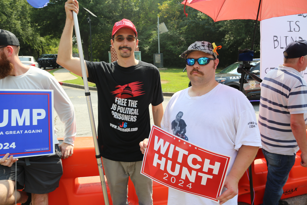 Daniel Demoura, left, of Boston, came to Atlanta to support former President Donald Trump outside the Fulton County Jail on August 24, 2023.