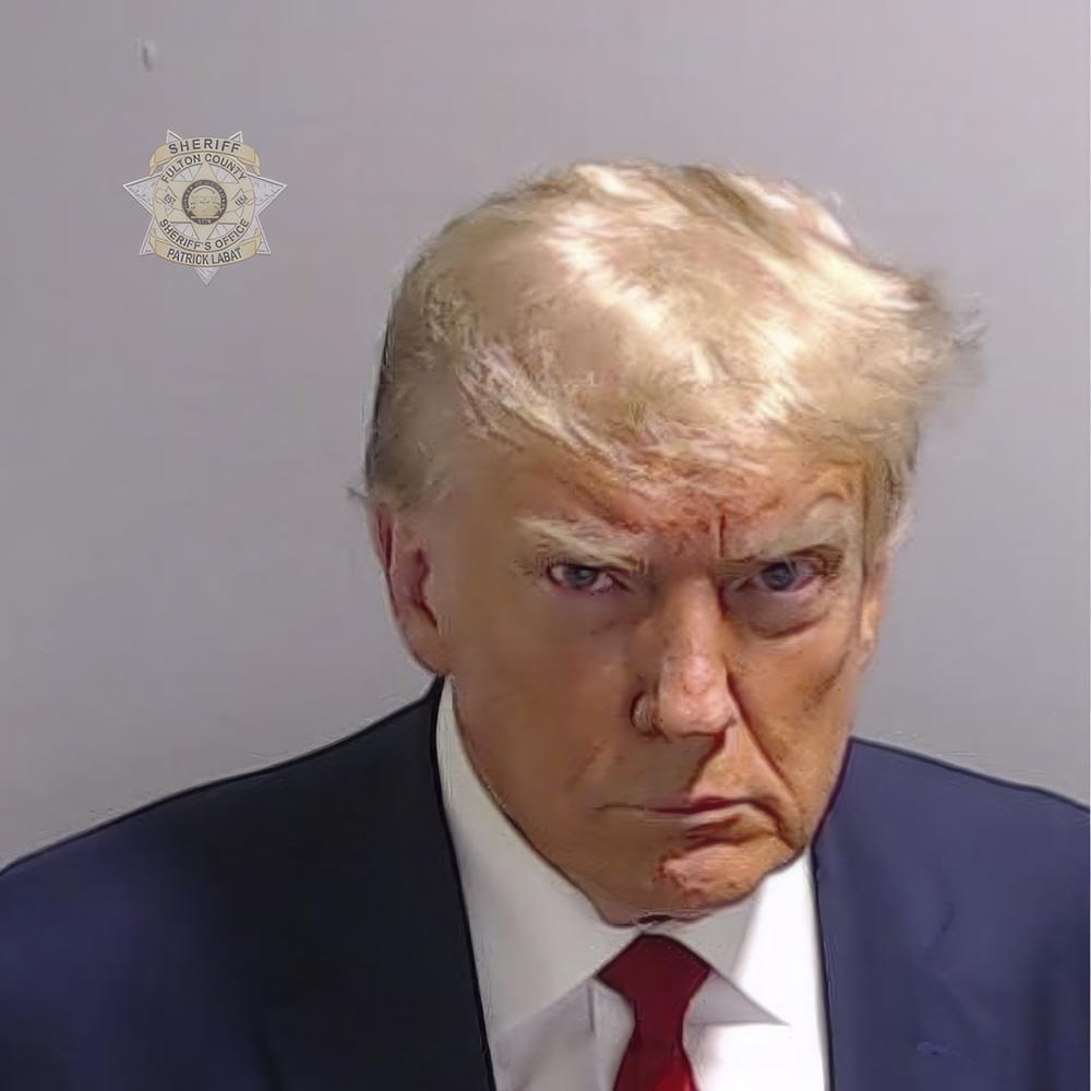 This booking photo provided by Fulton County Sheriff's Office, shows former President Donald Trump on Thursday, Aug. 24, 2023, after he surrendered and was booked at the Fulton County Jail in Atlanta. Trump is accused by District Attorney Fani Willis of scheming to subvert the will of Georgia voters in a desperate bid to keep Joe Biden out of the White House.