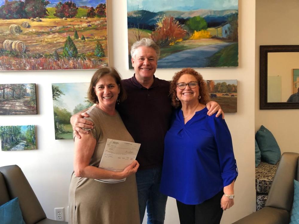 Arts Alliance Executive Director Julie Wilkerson, left, and the Griffith Foundation’s Lisa Garrett pose with actor Michael O’Leary during a check presentation in April. 