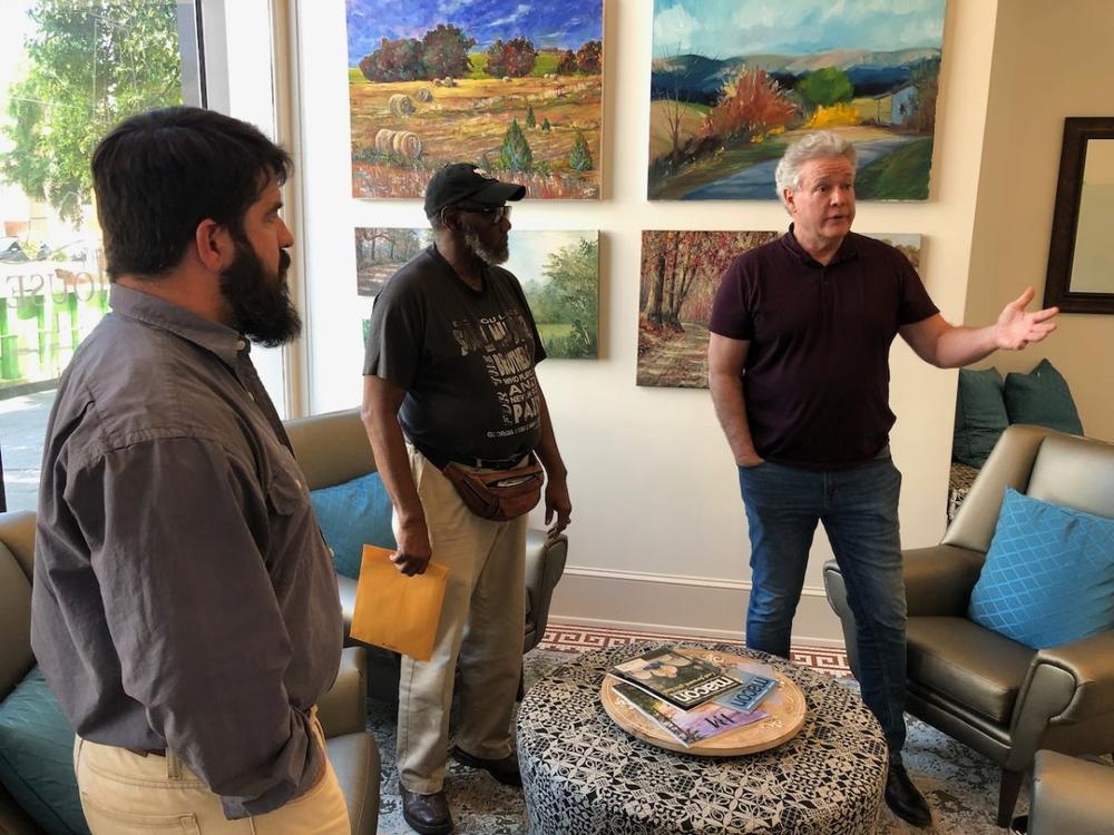 Actor and playwright Michael O’Leary, right, discusses his play “Breathing Under Dirt” with Joshua Hale, left, and Newton Collier at the Griffith Foundation headquarters on Mulberry Street in April.