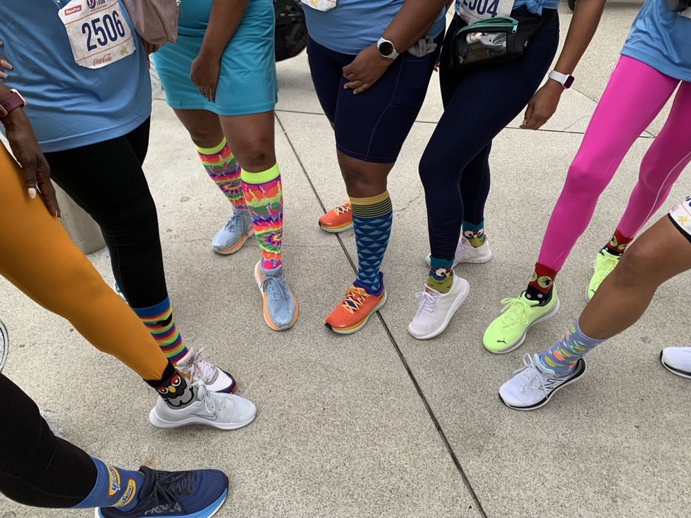 Runners sport their “crazy socks” at the 2023 RaceTrac Run for Research at Truist Park on Sept. 6, 2023.  