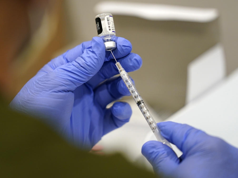 A healthcare worker fills a syringe with the Pfizer COVID-19 vaccine at Jackson Memorial Hospital Tuesday, Oct. 5, 2021.