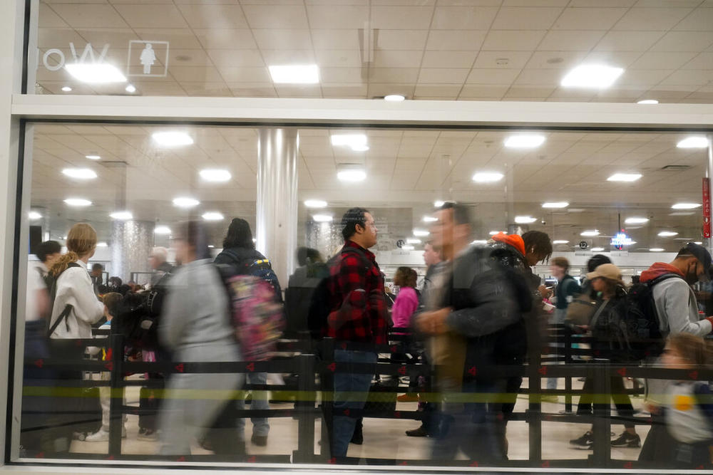 Travellers wait to go through security at the Hartsfield-Jackson Atlanta Airport in Atlanta, Tuesday, Nov. 22, 2022. 