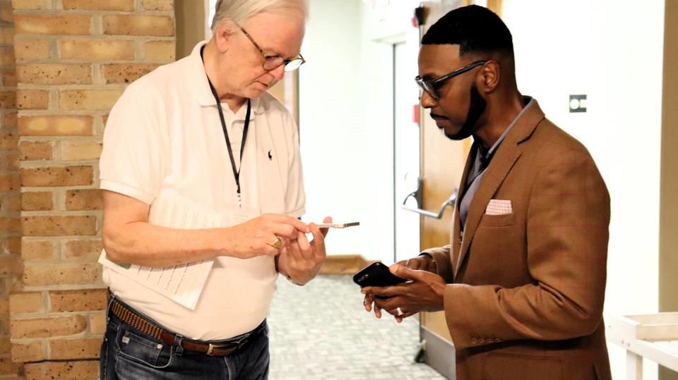 Pastor Bob Farrow of St. Nicholas Episcopal in Hamilton, Georgia, and Pastor Willie J. Barber II of Prospect A.M.E. meet and share contact information at the Green Team Summit. 
