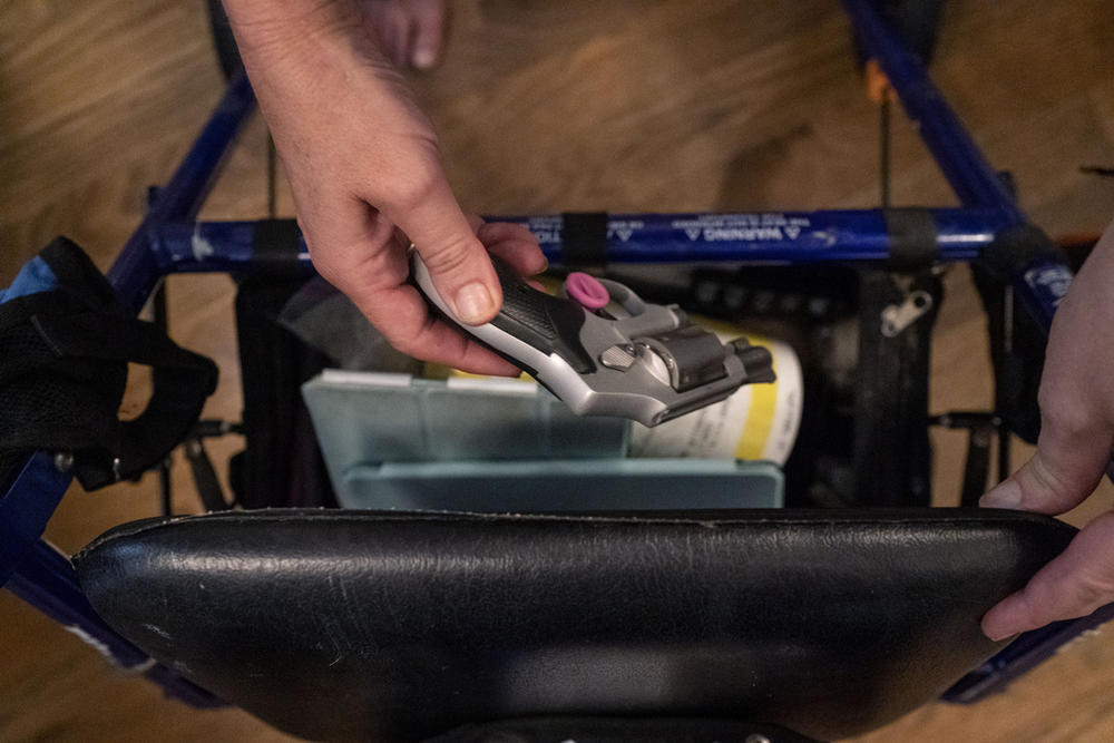 Janet Paulsen shows the gun she sometimes keeps in her walker at her home in Acworth, Ga., Monday, Aug. 7, 2023. “So I am not about willy-nilly taking guns away from people. But if you’re threatening to kill someone, yeah, you need to surrender that firearm.”