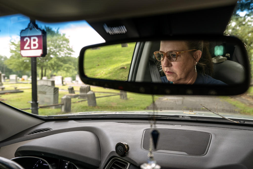 Janet Paulsen drives through the cemetery in Acworth, Ga., Tuesday, Aug. 8, 2023, where she said her estranged husband used to park with their twins and drink before coming home. “Isn’t that sick?” she asked out loud. 