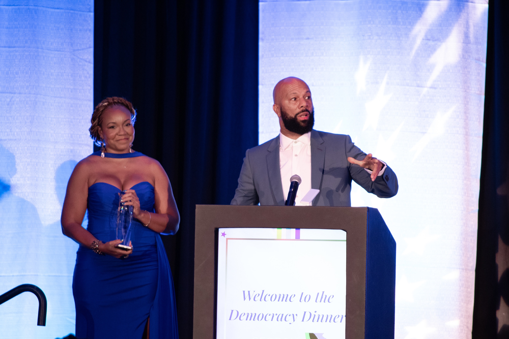 Common accepts an award from the Georgia Alliance for Progress on Oct. 12, 2023.