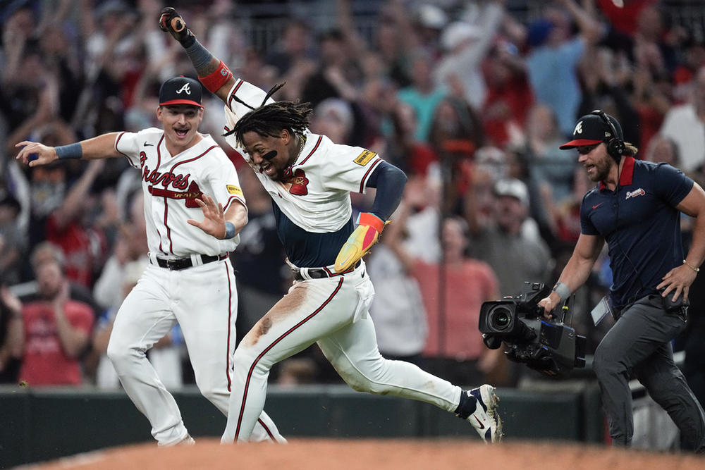 Atlanta Braves' Ronald Acuña Jr. celebrates after scoring the winning run on an Ozzie Albies base hit during the 10th inning of a baseball game against the Chicago Cubs, Wednesday, Sept. 27, 2023, in Atlanta. Acuña stole two bases in the game to become the first player in the majors to steal 70 bases and hit 40 home runs in a season.