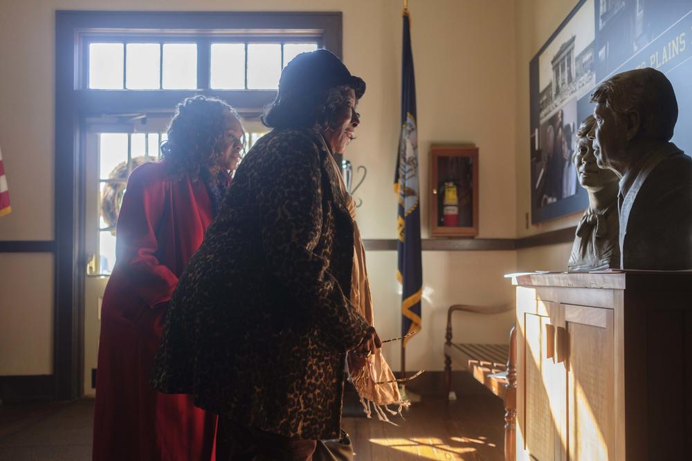 Angela Foster, left, of Americus, Ga. and Myrtle Habersham of Macon, Ga. look at a bust of the Carters in the former Plains High School. Both women like Rosalind Carter work to support caregivers. Both women remember fondly the handwritten notes they would receive from her.