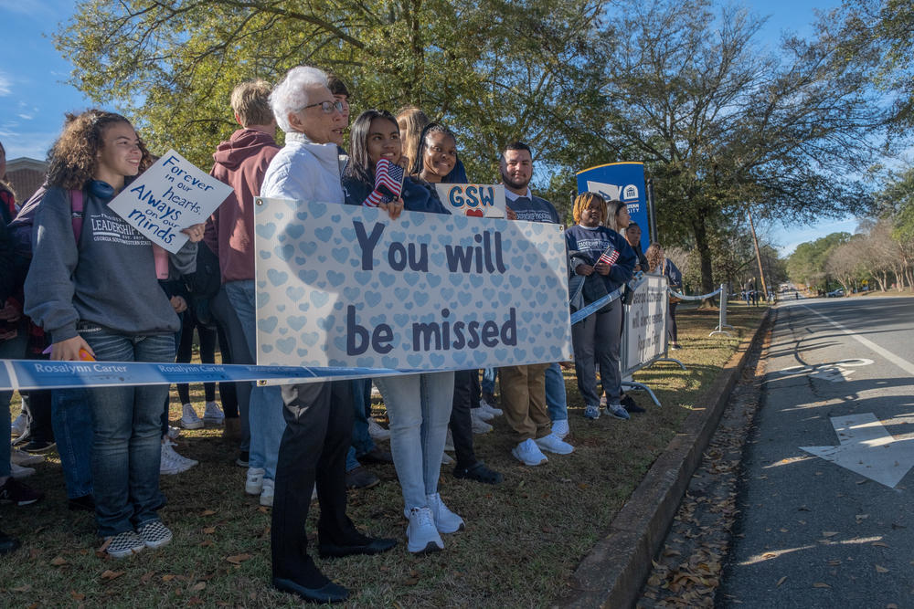 Students and teachers from Georgia Southwestern State University, Rosalynn Carter's alma mater, watch as a motorcade carrying the former First Lady to Atlanta makes its way through campus.