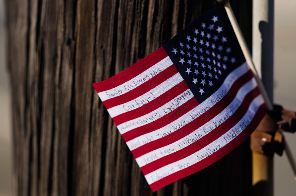 A message written to Rosalynn Carter on a flag pinned to a utility pole along the funeral route. 