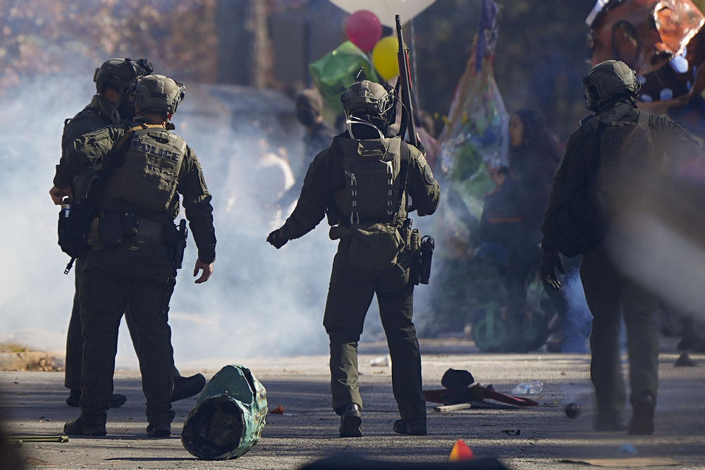Police officers confront protesters during a demonstration in opposition to a new police training center, Monday, Nov. 13, 2023, in Atlanta.