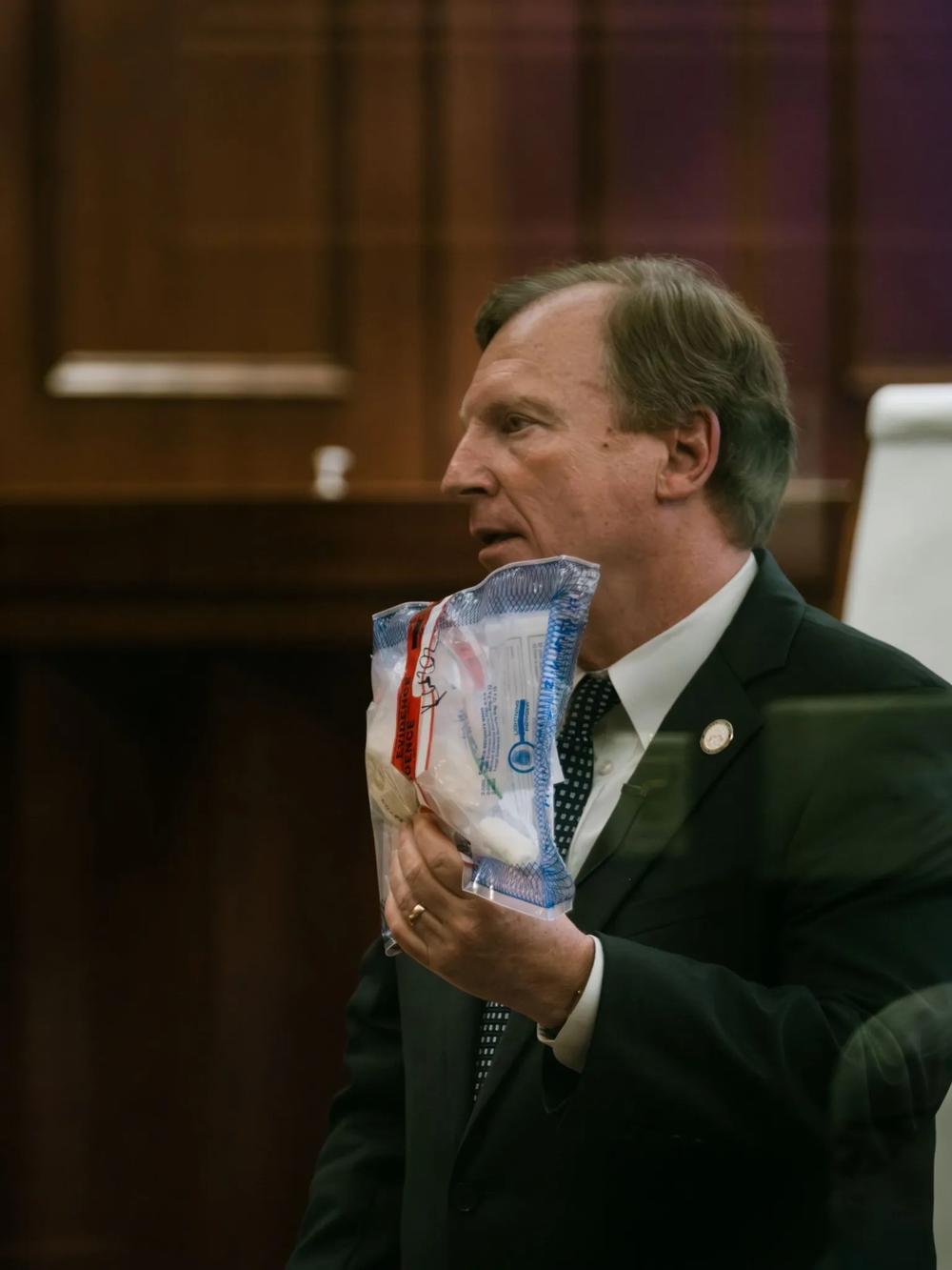 Brunswick Judicial Circuit District Attorney Keith Higgins holds a white substance he said was tested as cocaine and found at Varshan Brown’s house following a fatal May 4, 2021 drug raid. “The truth of this case is Varshan Brown is a drug dealer. That he makes profit upon the misery of others. That he peddles this poison called cocaine to our children, to our brothers and our sisters in Camden County.” Credit: Justin Tyalor/The Current