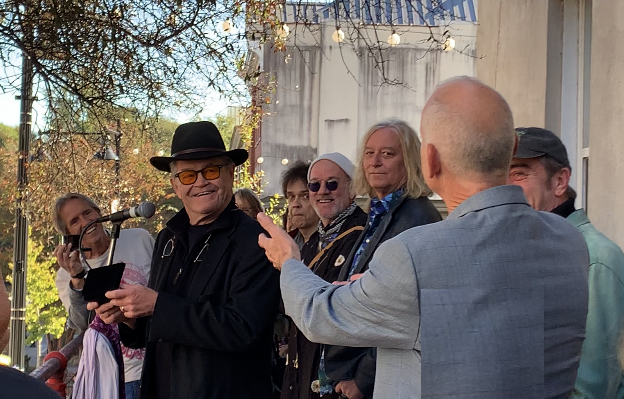 Singer Micky Dolenz of the Monkees accepts a ceremonial key to the city of Athens, Ga. from Mayor Kelly Girtz (right) on Nov. 3, 2023 as R.E.M. members Michael Stipe, Peter Buck, Bill Berry and fellow musicians watch. 