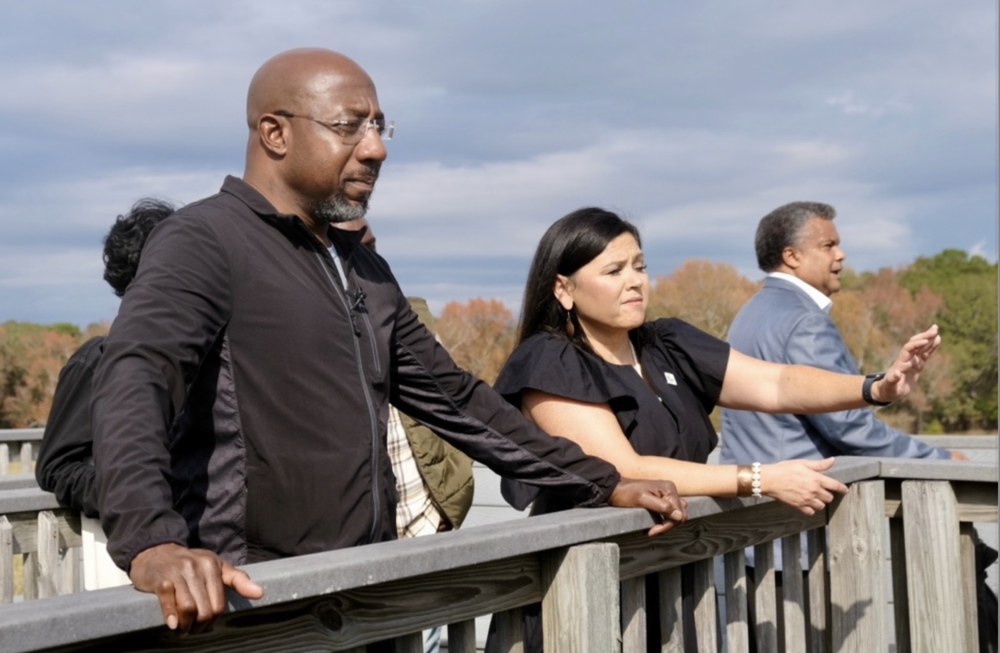 Tracie Revis, a citizen of the Muscogee Creek Nation, admires the view from the Great Temple Mound complex with Sen. Warnock during his tour of Ocmulgee National Historic Park on Nov. 20, 2023.