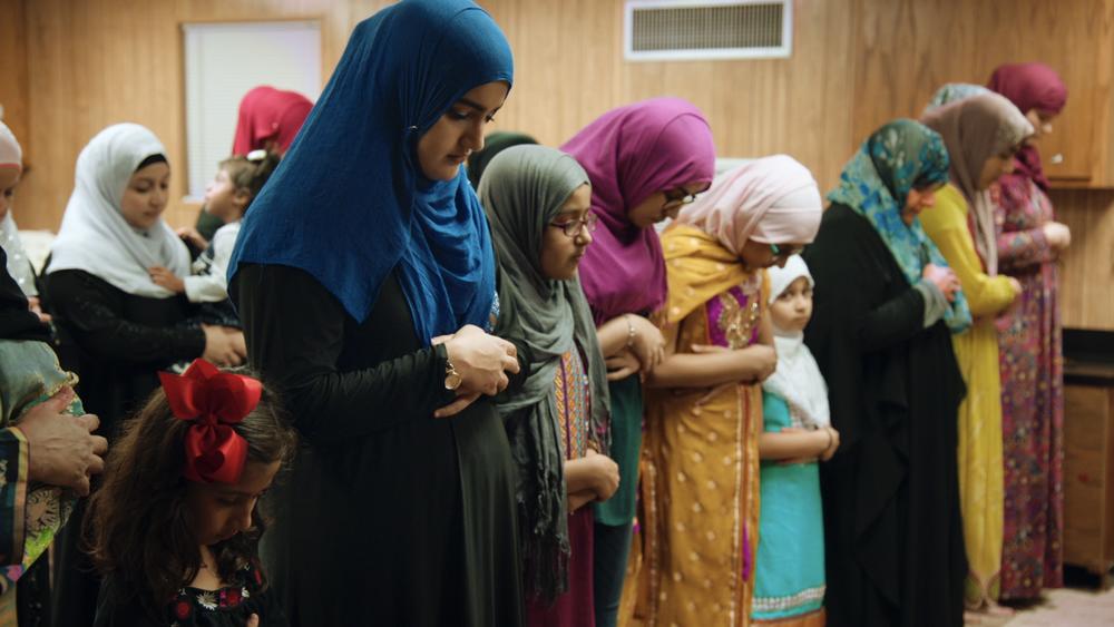 Women of the Victoria Islamic Center pray in a temporary building after an arson destroys their mosque. 