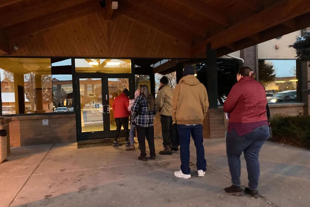 People line up outside a public assistance office in Missoula, Montana, before its doors open at 8 a.m., Oct. 27, 2023, to try to regain Medicaid coverage after being dropped from the government insurance program for people with low incomes and disabilities. Each said they had experienced long waits on the state's phone helpline.