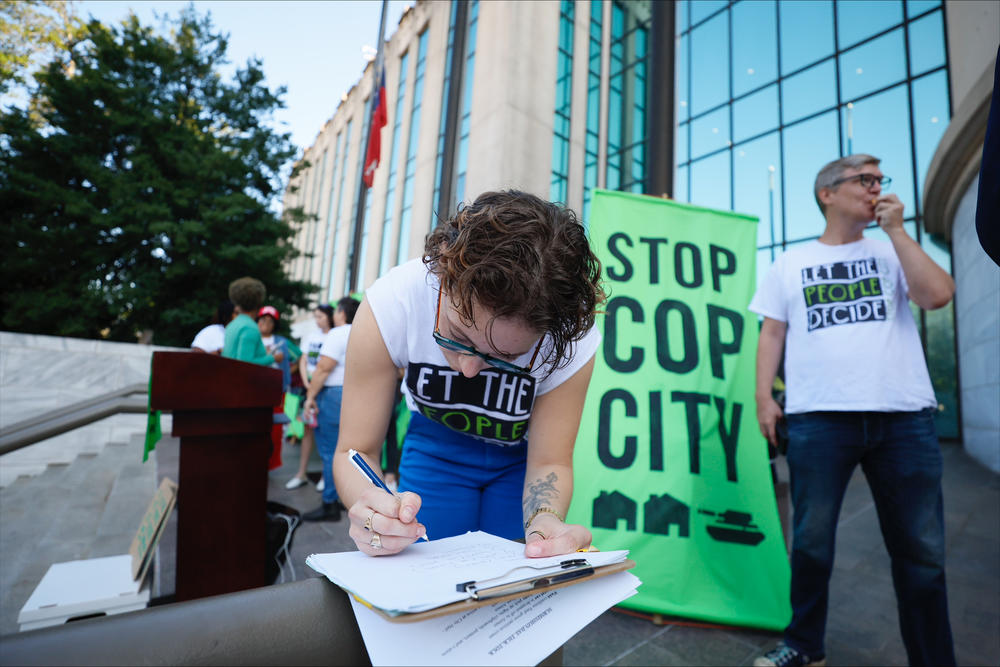 Activists gather outside Atlanta City Hall, Monday, Sept. 11, 2023, where they delivered dozens boxes full of signed petitions to force a referendum on the future of a planned police and firefighter training center. An analysis of petition entries by four news organizations finds it’s unclear whether petitioners have enough valid entries to force the citywide vote, with nearly half the entries unable to be matched to eligible registered Atlanta voters.