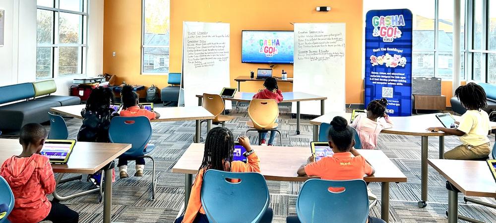 Kids play the GASHA GO! World games on ipads in a Boys and Girls Club loft