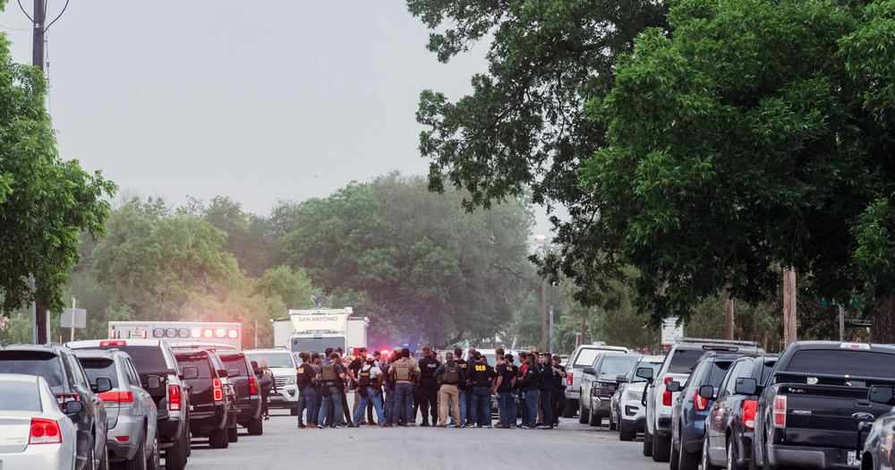 A crowd of law enforcement officers standing in a street.